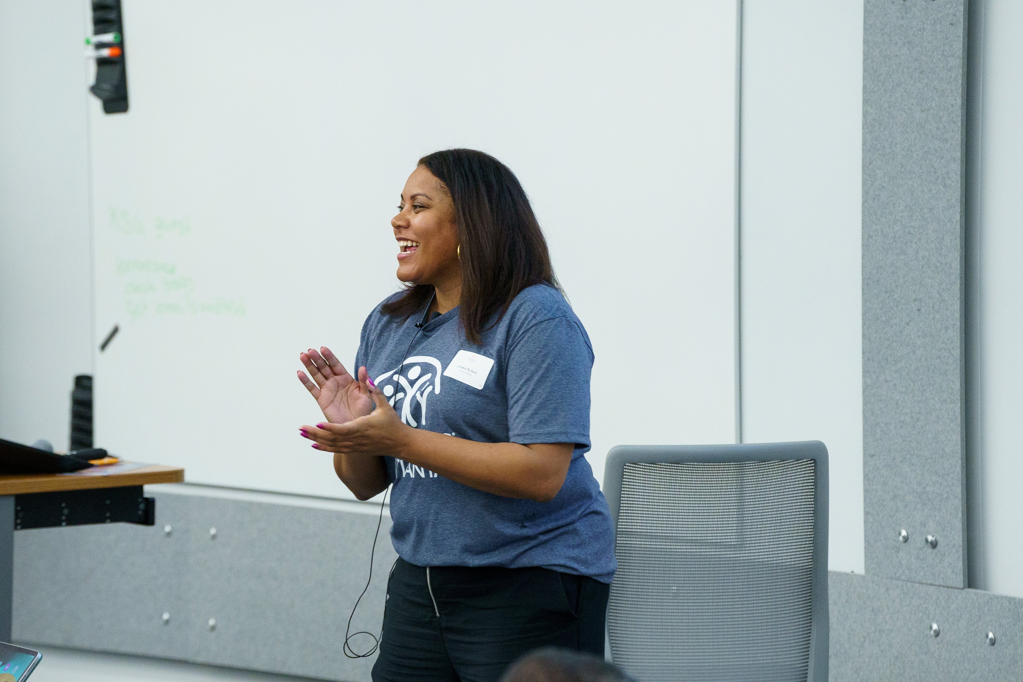 LaVasia Bullard smiling and clapping leading the event day 